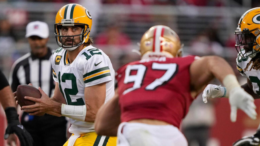Aaron Rodgers throws a pass and lands the Packers in the NFL Playoffs.